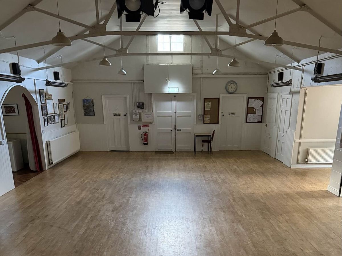 The empty main hall seen from the stage, with stage lights overhead